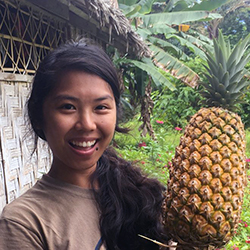 Image of young woman holding a pineapple